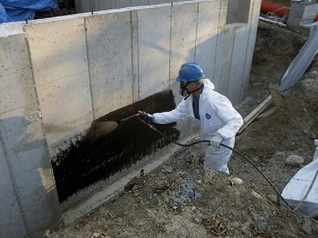 Professional waterproofing the exterior walls of the basement in Oakland, CA
