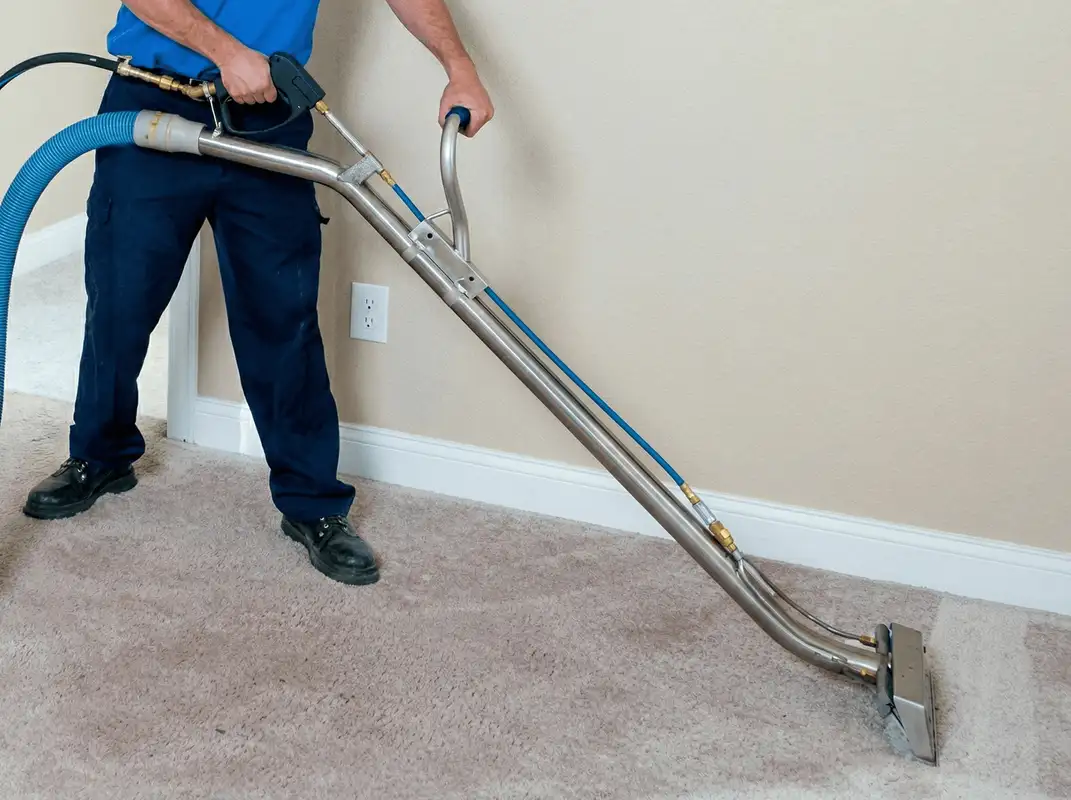 Professional operating a liquid removal machine on a carpeted floor in Oakland, CA